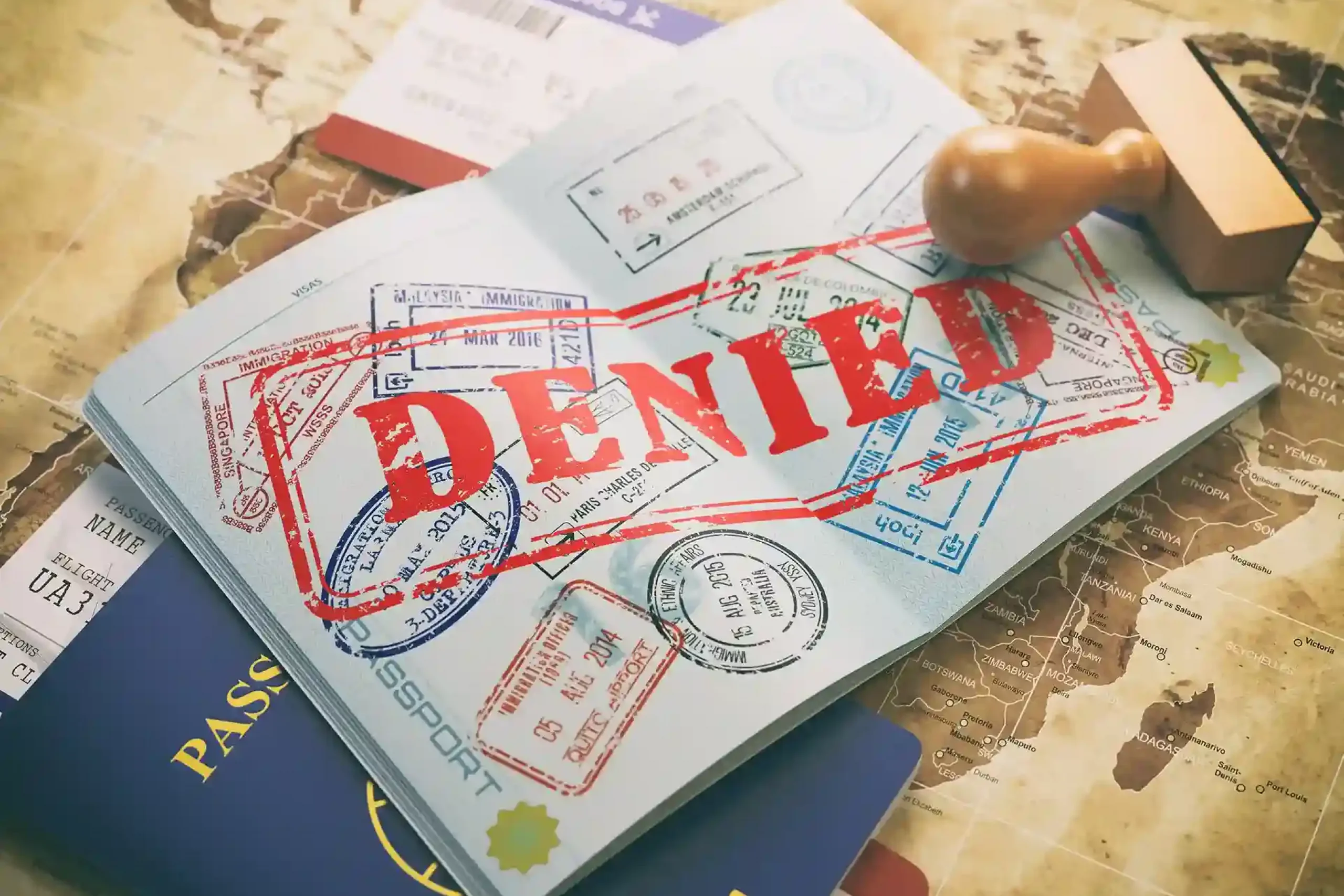 passport-with-denied-visa-stamp-map-world-airline-boarding-pass-ticketstravel-concept_11zon (1)